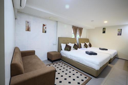 Ένα ή περισσότερα κρεβάτια σε δωμάτιο στο Hotel Pesona Timur