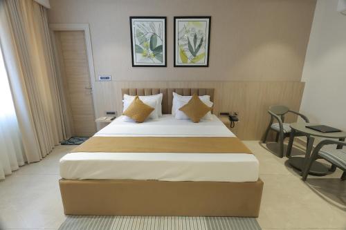 a bedroom with a large bed and a table at Hotel Dreamz in Karnal