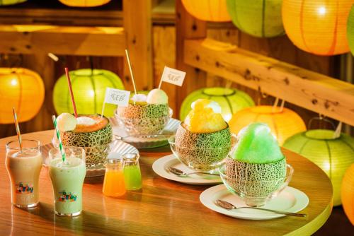 a table topped with plates of food and drinks at BEB5 Tsuchiura by Hoshino Resorts in Tsuchiura