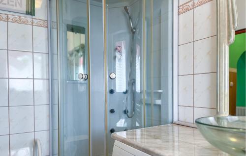 a shower with a glass door in a bathroom at 4 Bedroom Amazing Home In Nowe Warpno in Nowe Warpno