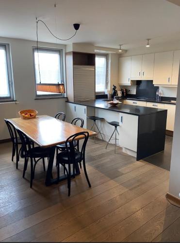 a kitchen with a table and chairs in a kitchen at Business Accommodation Luxury XL Geel in Geel