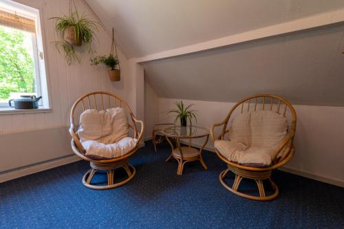 a room with two chairs and a glass table at Holmely Bed & Breakfast in Brædstrup