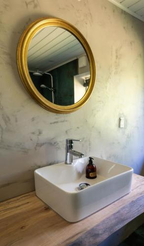 a bathroom with a white sink and a mirror at Holmely Bed & Breakfast in Brædstrup