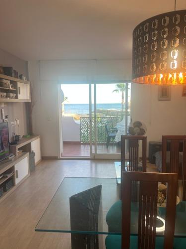 a living room with a glass table and a view of the ocean at Apartment zona Naturista in Vera