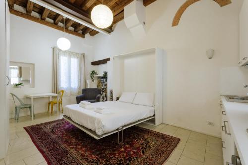 a bedroom with a bed and a living room with a table at Yourbanflat Art Loft in Padova