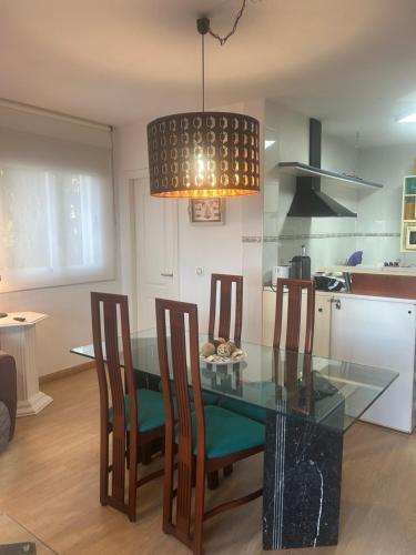 a dining room with a glass table and chairs at Apartment zona Naturista in Vera