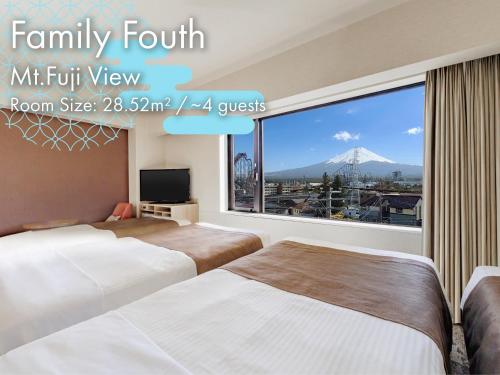 a hotel room with two beds and a large window at HOTEL MYSTAYS Fuji Onsen Resort in Fujiyoshida