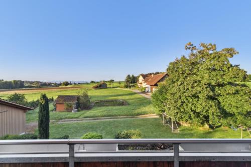 a view of a house with a field and trees at VK - VB - Zürich Airport - Homestay - Villa Bänikon in Kloten
