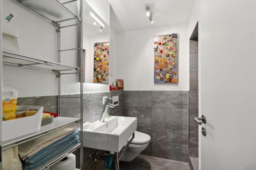 a bathroom with a sink and a toilet at VK - VB - Zürich Airport - Homestay - Villa Bänikon in Kloten