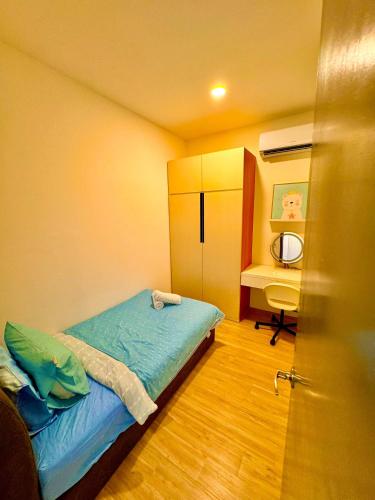 a small bedroom with a bed and a desk at The Podium Kuching Luxury 6pax 3BR HFloor Facing Aeon in Kuching