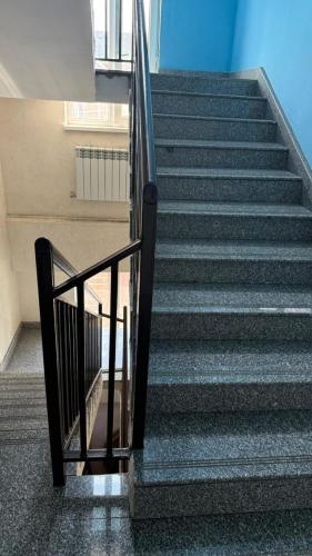 a staircase in a building with a metal railing at Пана in Almaty