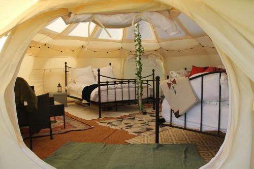 a bedroom with two beds in a tent at Tal-y-fan farm 6m stargazer tent in Bridgend