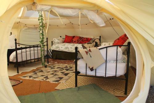 a bedroom with a tent with a bed and a chair at Tal-y-fan farm 6m stargazer tent in Bridgend