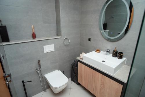 a bathroom with a sink and a toilet and a mirror at Blue Palm Pool, quiet and comfort in Tangier in Tangier