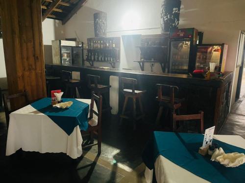 a restaurant with two tables and a bar at The View - Xai Xai Mozambique Xai Xai Beach Front 180 Degree Sea Views in Xai-Xai