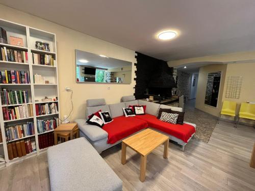 a living room with a couch and a red blanket at Couleurs de la vie - Chambres d'Hôtes et Gîte in Cormatin