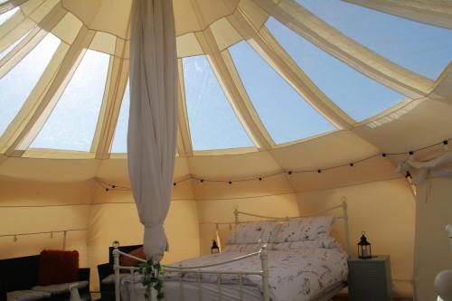 a bedroom with skylights in a roof at Tal-y-fan farm 6m stargazer tent in Bridgend