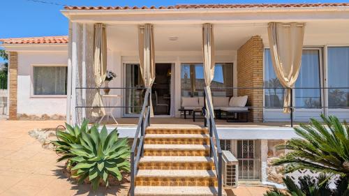 a villa with a staircase leading to a house at VILLA Rübezahl in Benidorm