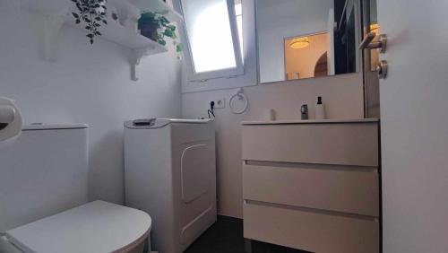 a small bathroom with a toilet and a sink at Casa Blanca 42 – Piscina, BBQ y Wifi (5 pax) in Tossa de Mar