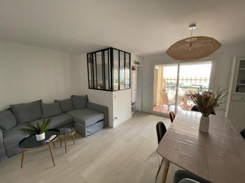 un salon avec un canapé et une table dans l'établissement Central, terrasse, proche plage et toute proximité, à Cavalaire-sur-Mer