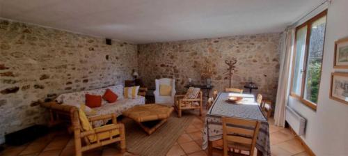 a living room with a couch and a table at Camping - Piscine - ccbbaah in Quinson