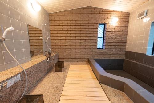a large bathroom with a shower and a tub at 箱根御泊処-TOGA- 045h in Hakone