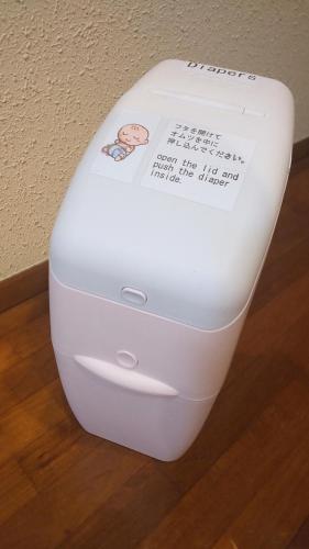 a white toilet sitting on top of a wooden floor at THE TORII in Kumamoto
