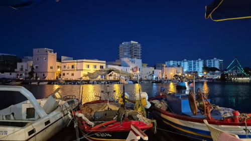 two boats are docked in a harbor at night at In The Heart Of Medina Bizerte and 5 min from the beach in Bizerte