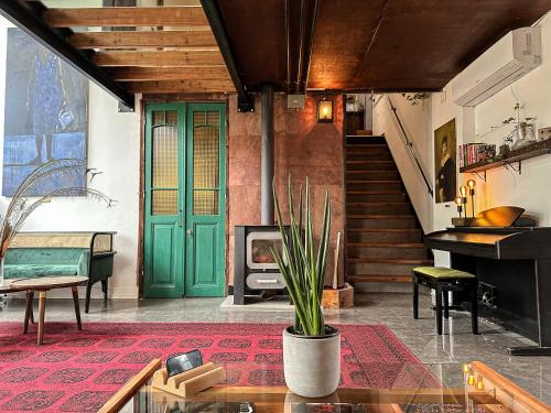 a living room with a green door and a fireplace at otto7senses in Haifa