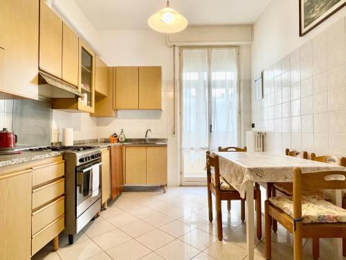 a kitchen with a table and a dining room at 3 Camere Terrazzo e Posto Auto - Praga 36 in Rimini