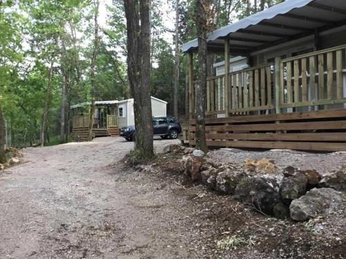 a house with a car parked in front of it at Camping 3 étoiles - ccaiaah in Monoblet