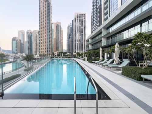 a swimming pool in a city with tall buildings at SmartStay at Grande Signature - Downtown Dubai City Views - Brand New Luxury Apartments in Dubai