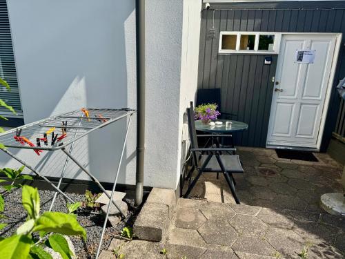 a table and a chair in front of a door at Villa Malena in Fensmark