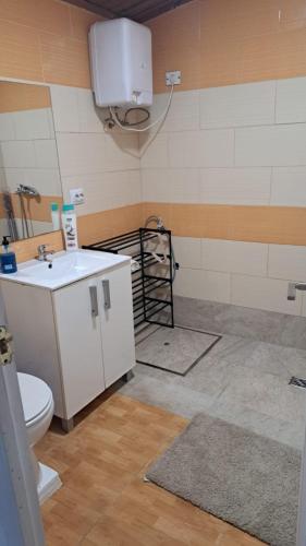 a bathroom with a white sink and a toilet at Villa Olga Rosa in Las Palmas de Gran Canaria