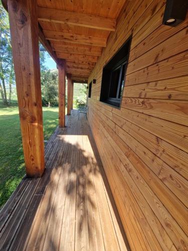 a wooden porch on a log cabin building at Chalet GOURCE avec vue sur le Château in Foix