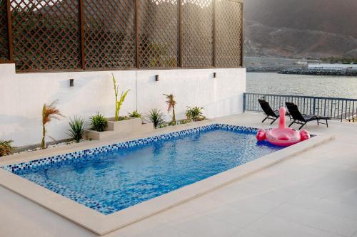a swimming pool with a pink pig in the middle of a house at Seascape Villa Marine in Fujairah