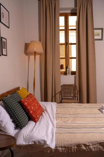 a bedroom with a bed with pillows on it at Buddha House Hotel and Cocktail Bar in Vlorë