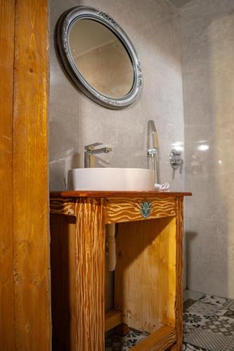a bathroom with a sink and a mirror on the wall at Buddha House Hotel and Cocktail Bar in Vlorë