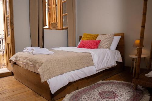 a bedroom with a bed with two pillows on it at Buddha House Hotel and Cocktail Bar in Vlorë