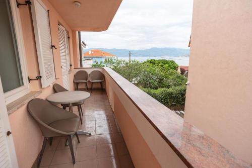 a balcony with chairs and a table and a view of the ocean at Villa Ana in Baška