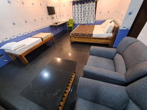 a living room with two beds and a couch at Ushodaya Resorts in Araku