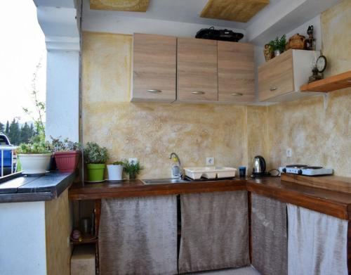 a kitchen with wooden counter tops and a sink at Apartment Merona with Swimming Pool in Trebinje