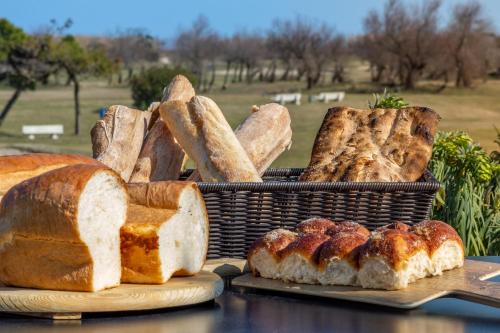 a basket filled with bread and other types of bread at Isola di Albarella Golf Hotel in Isola Albarella