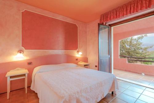 Postel nebo postele na pokoji v ubytování Hotel I Ginepri