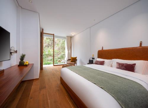 a bedroom with a large bed and a large window at Shanyu Life Huangshan Design Hotel in Huangshan