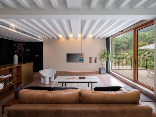 a living room with a couch and a table at Shanyu Life Huangshan Design Hotel in Huangshan