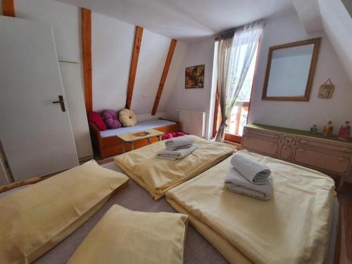 a room with two beds and a window at holiday house LID Bjelolasica in Jasenak