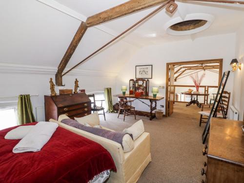 a bedroom with a red bed and a desk at Talbot Lodge in Stafford
