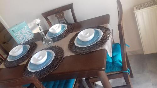 a table with blue and white plates on it at Magic Sea View apartment in Rafina