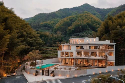 an aerial view of a house in the mountains at Shanyu Life Huangshan Design Hotel in Huangshan